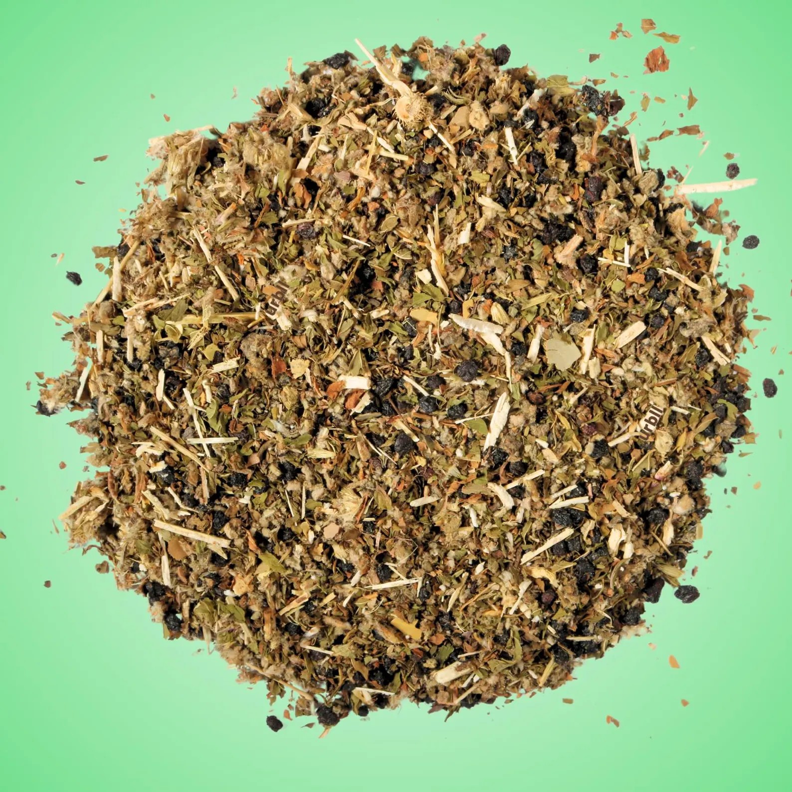 Loose leaf herbal mix on green background
